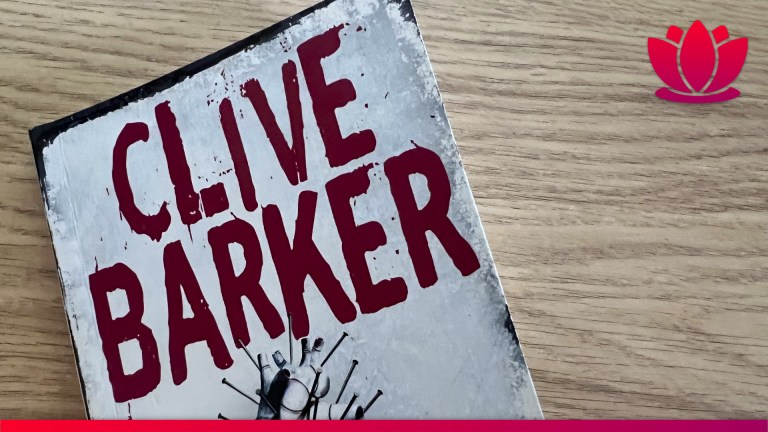Hellraiser book by Clive Barker front cover on a wooden desk