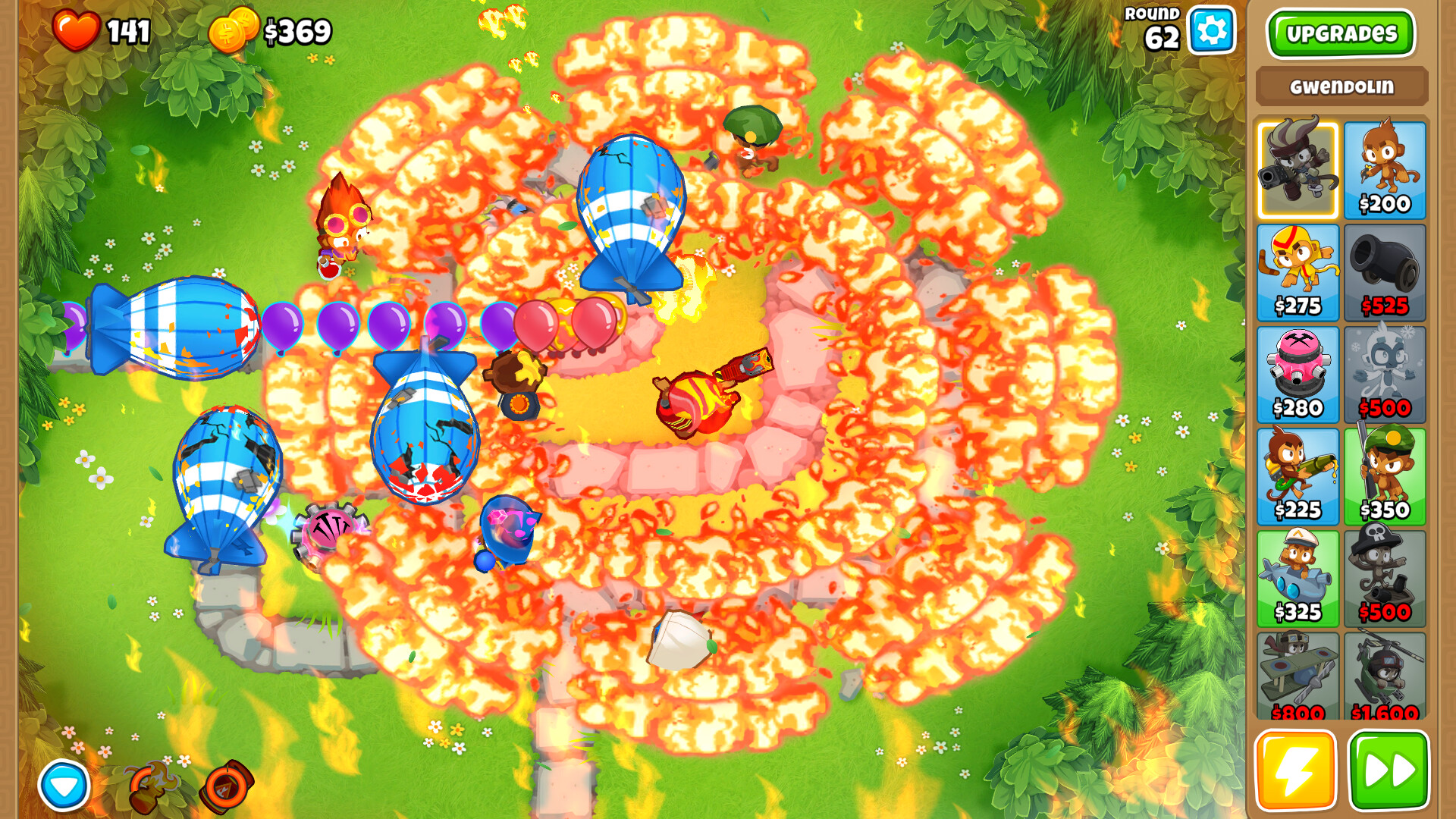 Bloons Defense TD 6 gameplay with MOABs and fire effects on screen.