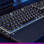 Skiff 100 Corsair keyboard shown on a dark desk with blue lights.